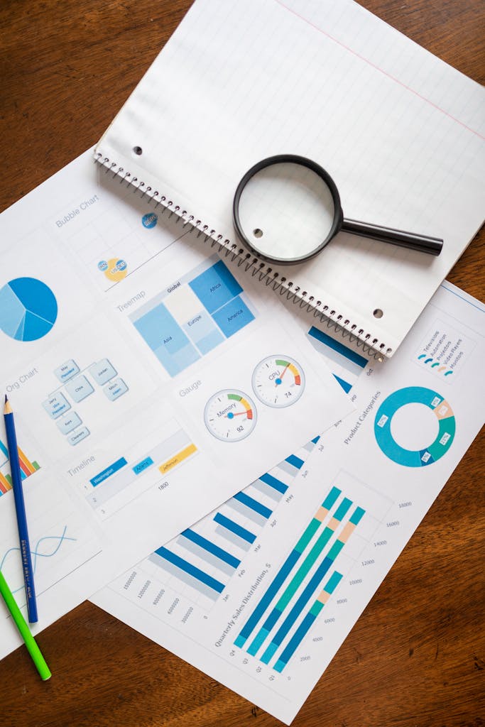 A set of charts and graphs with a magnifying glass, perfect for reports.
