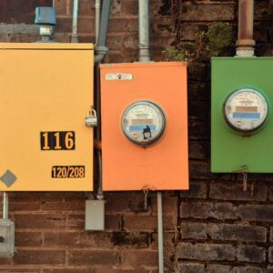 Three vibrant utility meters on a brick wall showcasing urban industrial design in Texarkana, Texas.