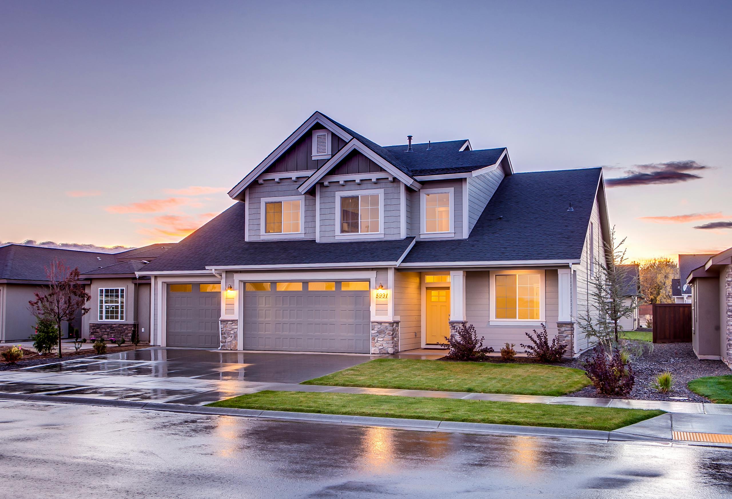 Buying a Home with Solar? What to watch out for... 1 Elegant suburban home with driveway at sunset showcasing modern architecture.