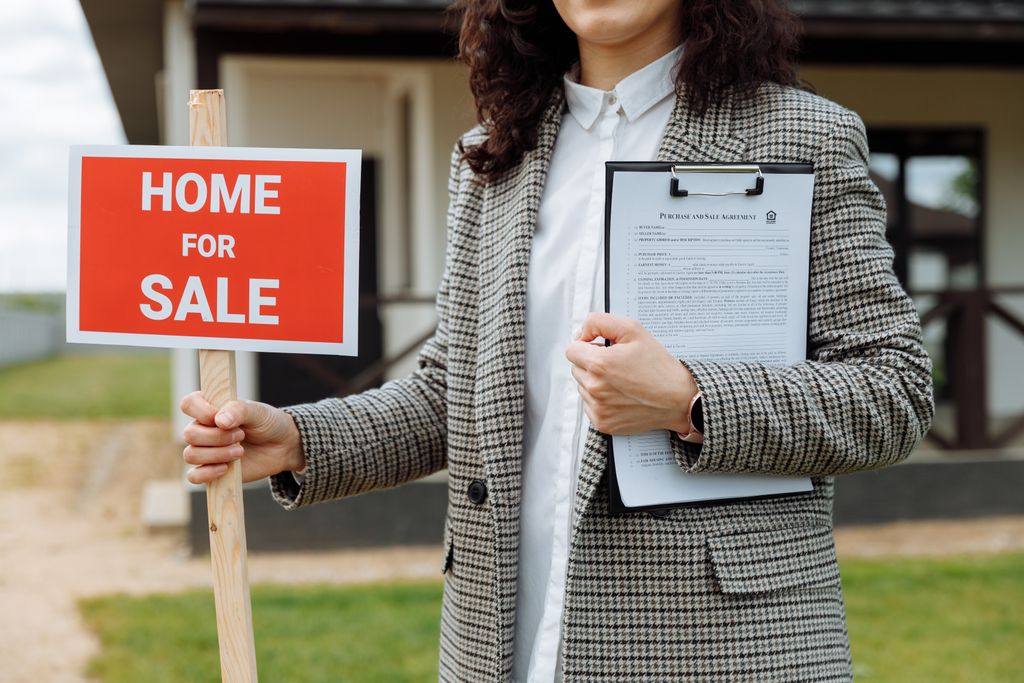 Selling a home with solar in sacramento, A real estate agent holding a home for sale sign and clipboard outside a property.