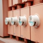 Close-up view of a row of industrial electricity meters for power monitoring and technology.