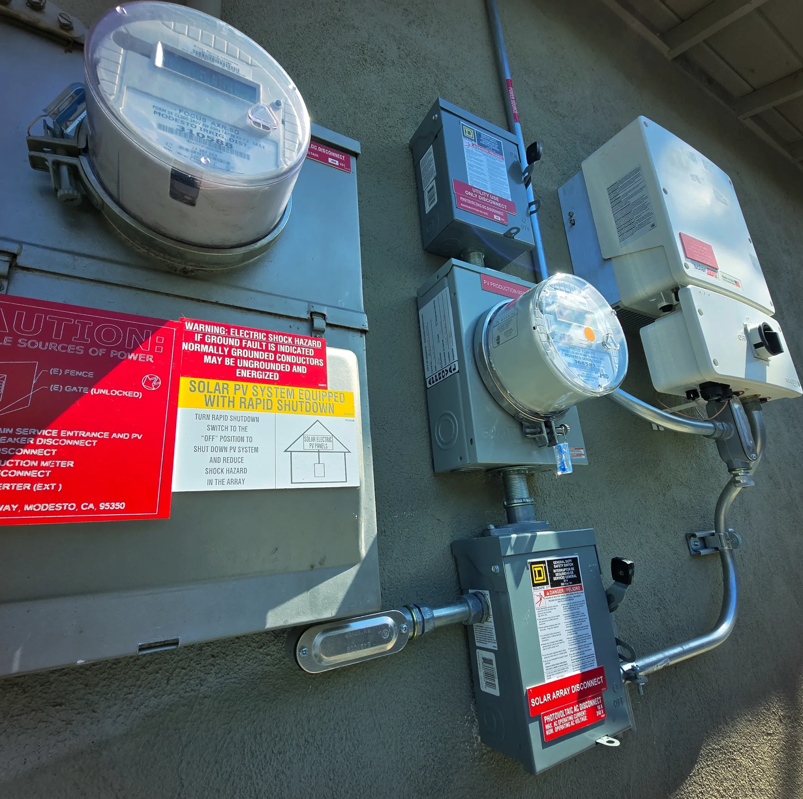 Residential solar equipment and utility meters being evaluated during an inspection
